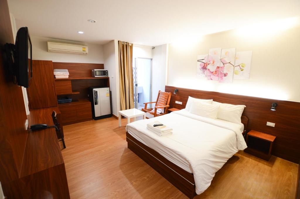 a hotel room with a bed and a television at Thaiphiphat house in Bangkok