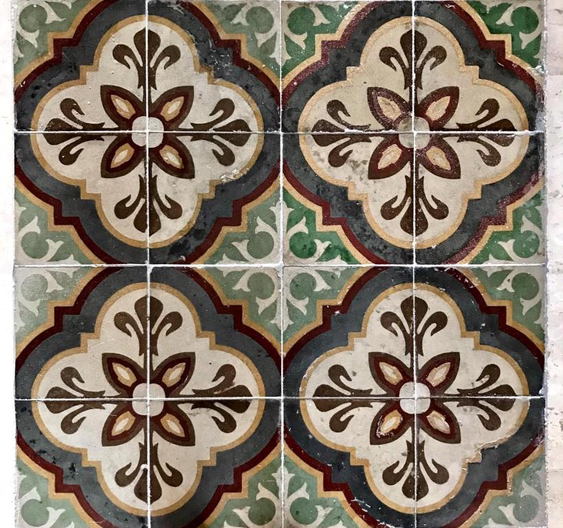 a tile floor with a pattern on it at sa ribera in Càbras