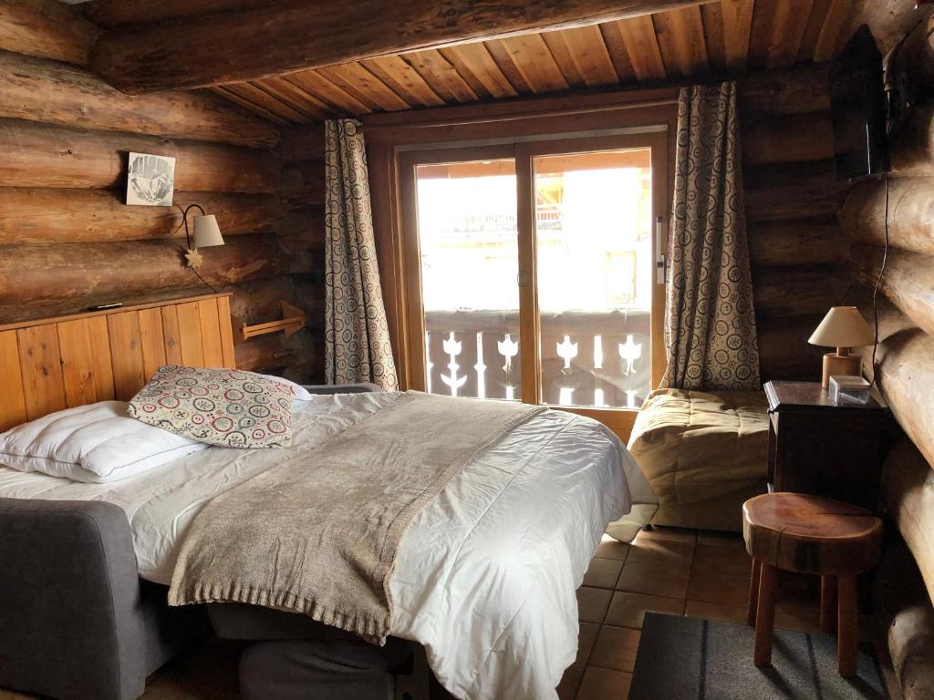 Postel nebo postele na pokoji v ubytování Chalet Le Ranch