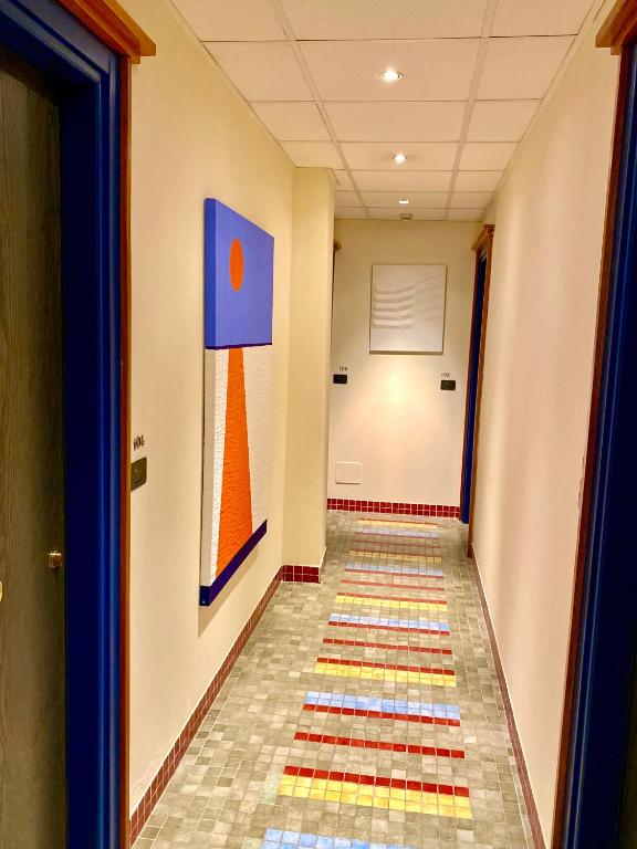 a hallway with a colorful tile floor in a building at Hotel Della Baia in Portovenere