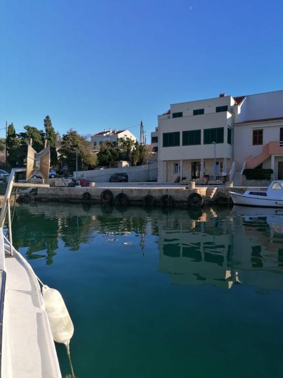 a view of a body of water with boats in it at Stara Kuća Apartments in Šimuni