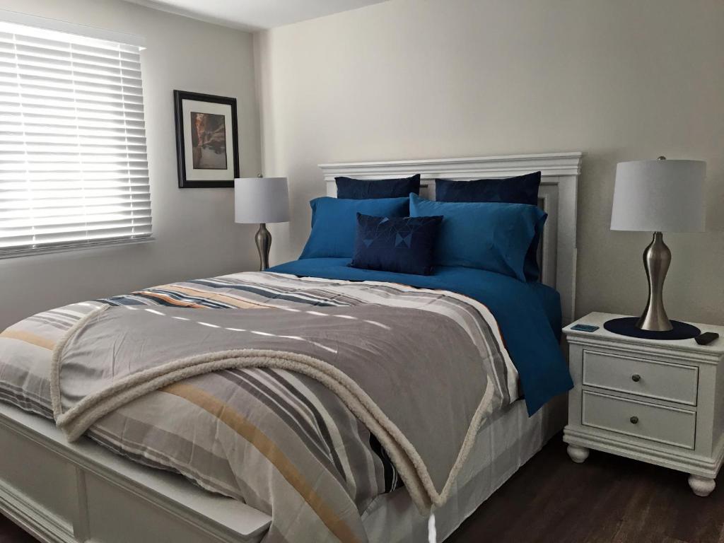 a bedroom with a large bed with blue pillows at Hammer Haus II in Waterloo