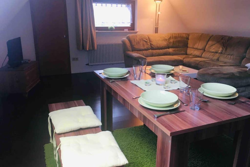 a living room with a wooden table and a couch at Monte Kali in Mittelkalbach