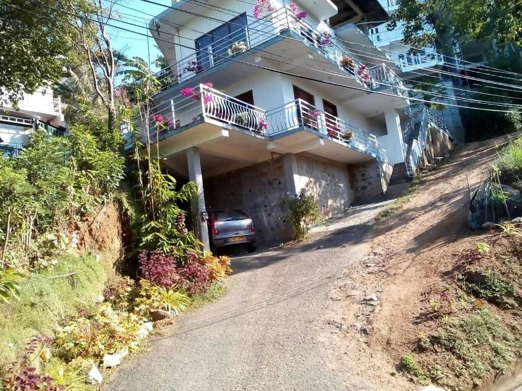 a house on the side of a dirt road at Sundil in Kandy