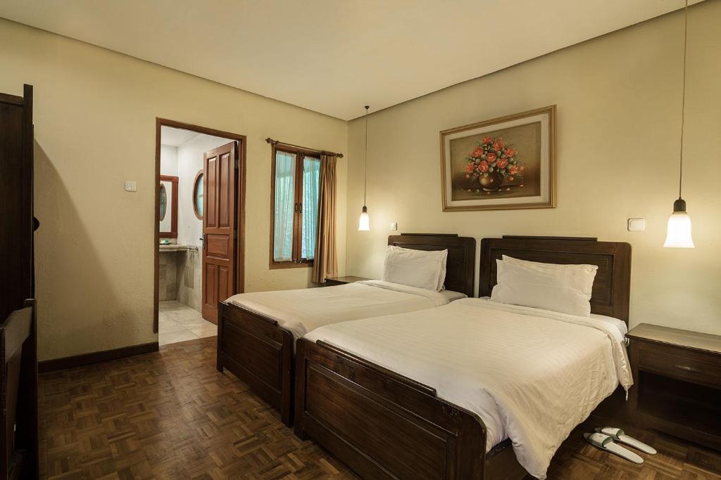 Postel nebo postele na pokoji v ubytování Puncak Pass Resort
