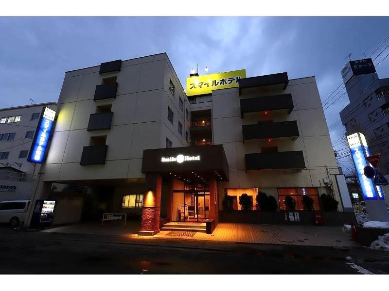 a large building with a store in front of it at Smile Hotel Aomori in Aomori