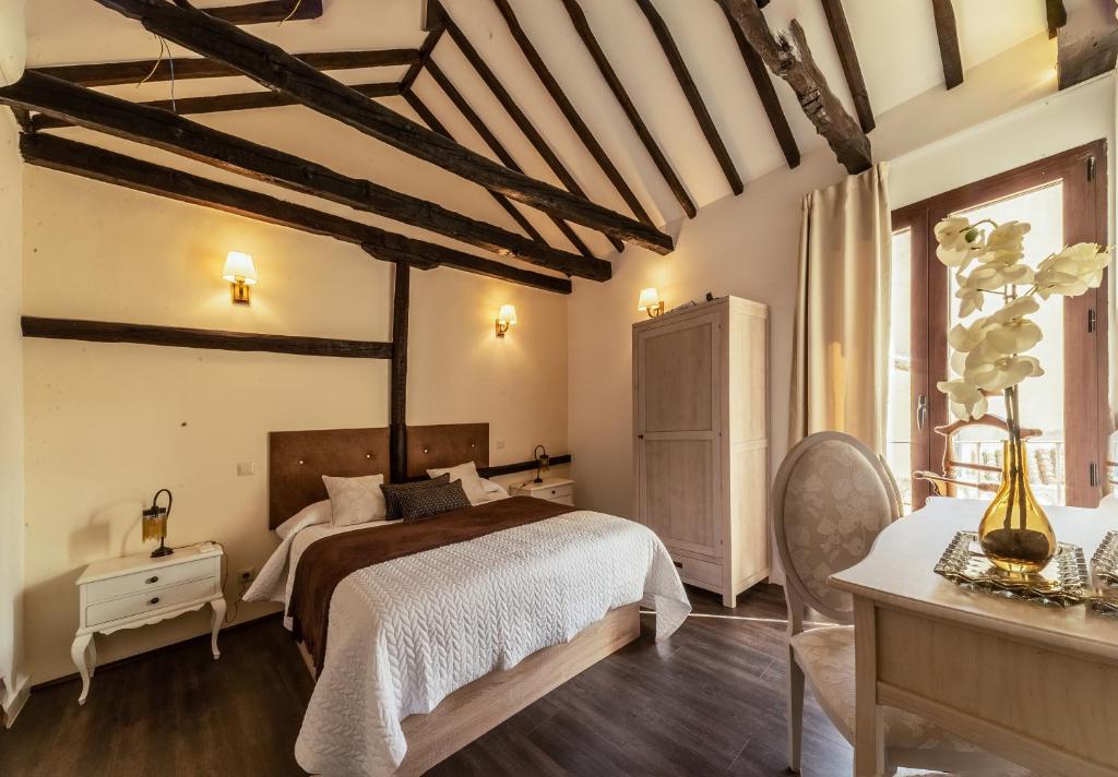 a bedroom with a bed and a dresser and a table at Tres Lunas in Toledo