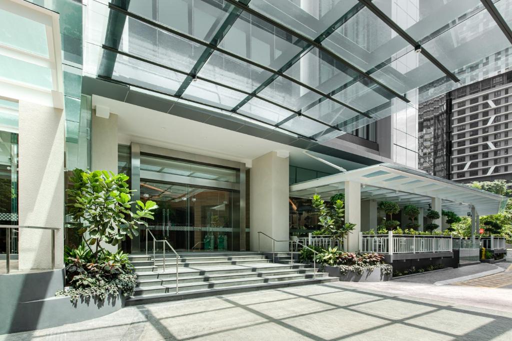 an office building with a glass ceiling and stairs at Komune Living in Kuala Lumpur