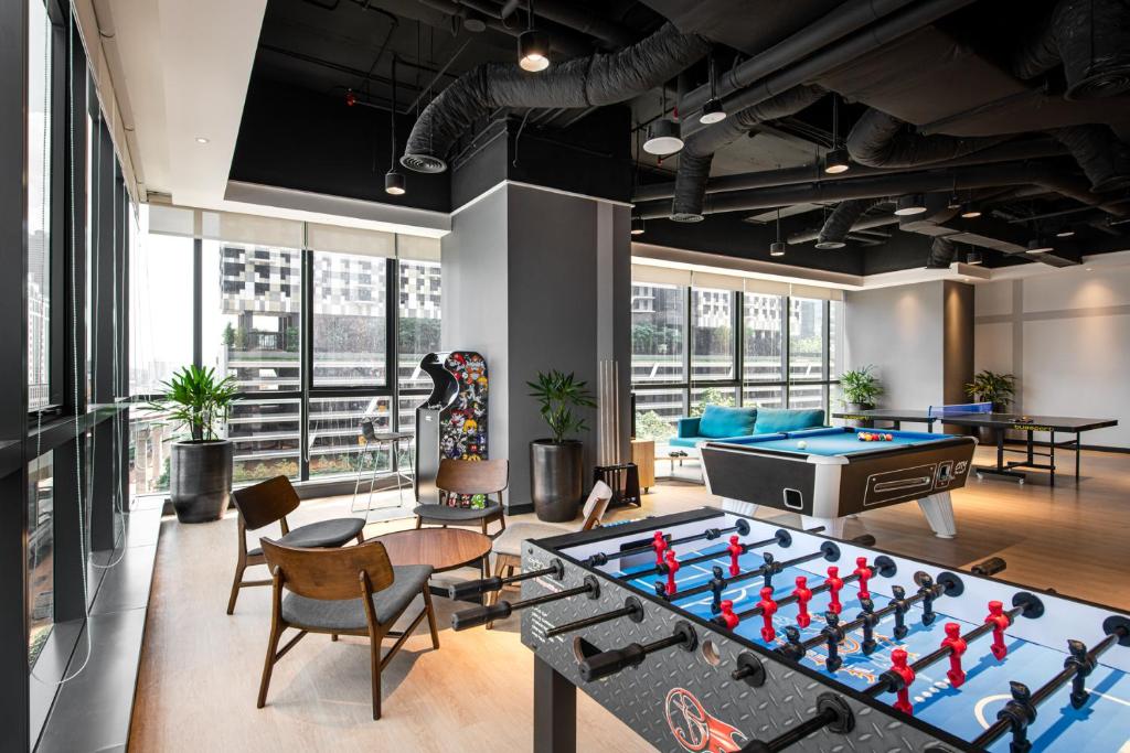 a living room with a large pool table and a pool table at Komune Living in Kuala Lumpur