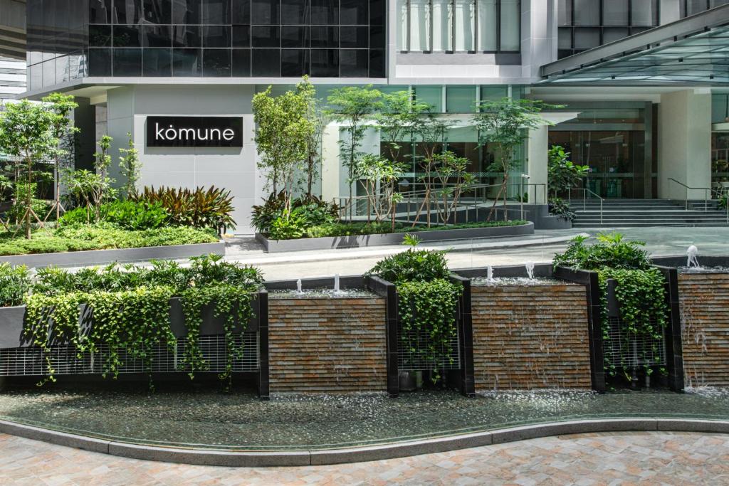 a fence in front of a building with plants at Komune Living in Kuala Lumpur