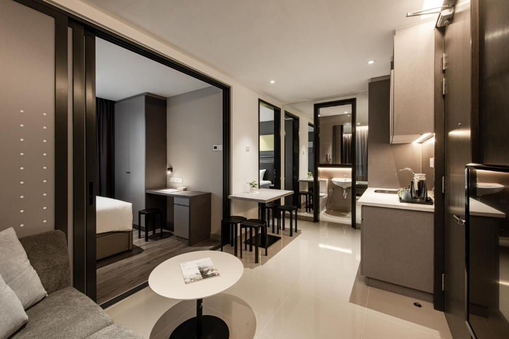 a kitchen and living room with a couch and a table at Komune Living in Kuala Lumpur