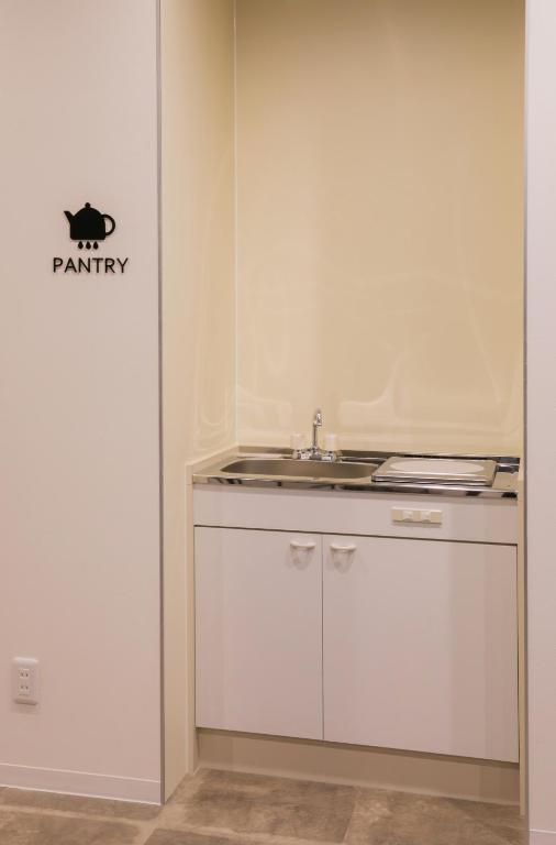 Kuchyň nebo kuchyňský kout v ubytování Hostel ilfaro Kurume