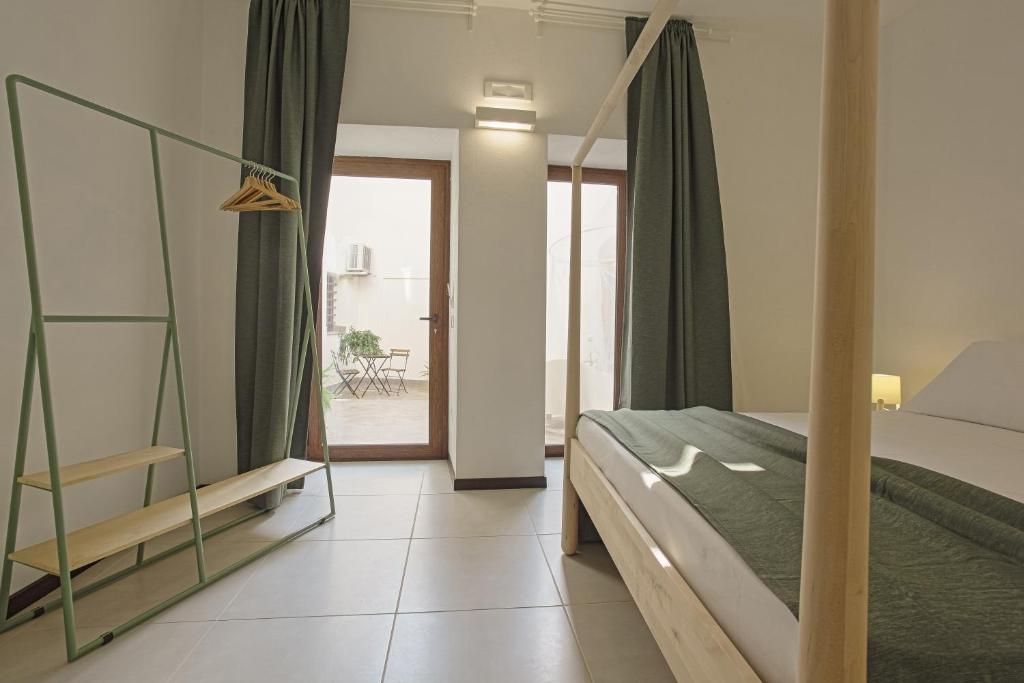 Postel nebo postele na pokoji v ubytování Cortile Baronello