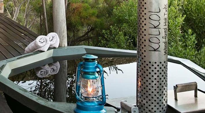 a blue bottle sitting on a table with a lantern at Hout Bay Holiday House in Hout Bay