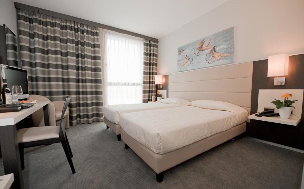Postel nebo postele na pokoji v ubytování Hotel Rivarolo