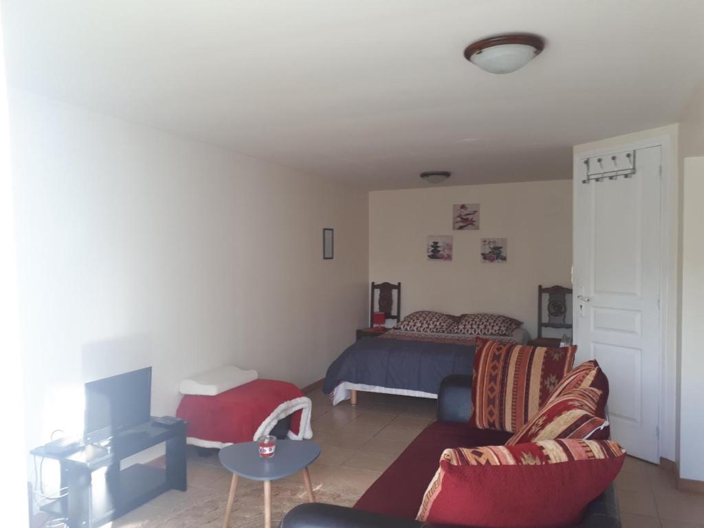 a living room with a bed and a couch at Bienvenue chez les GIBBS! in Sury-en-Vaux