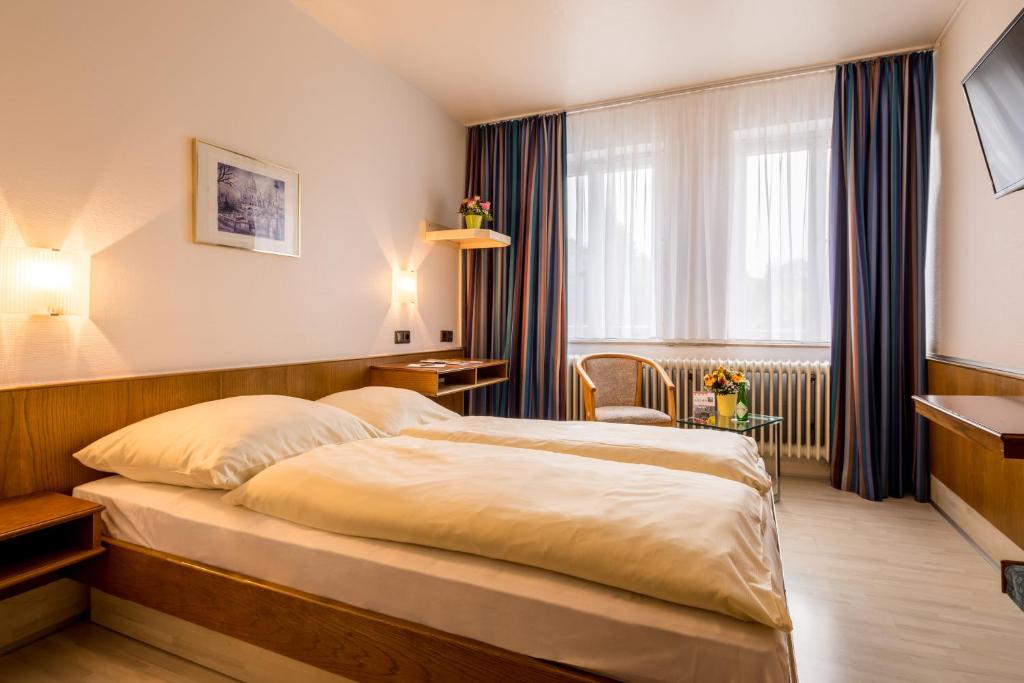 Postel nebo postele na pokoji v ubytování Hotel Buschhausen
