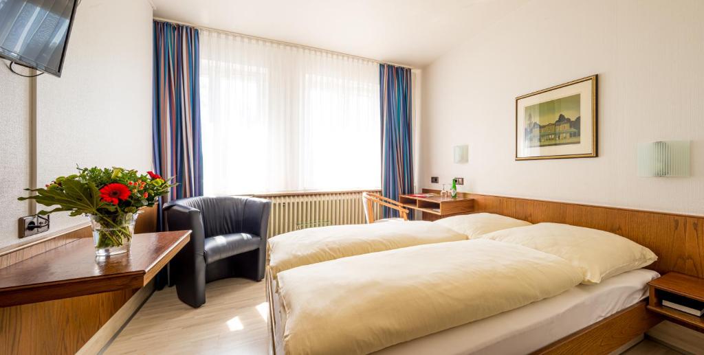 Postel nebo postele na pokoji v ubytování Hotel Buschhausen
