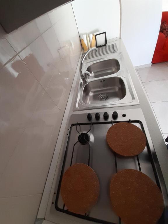 a stove top oven with a sink in a kitchen at San Marco Beach App Libeccio in Agropoli
