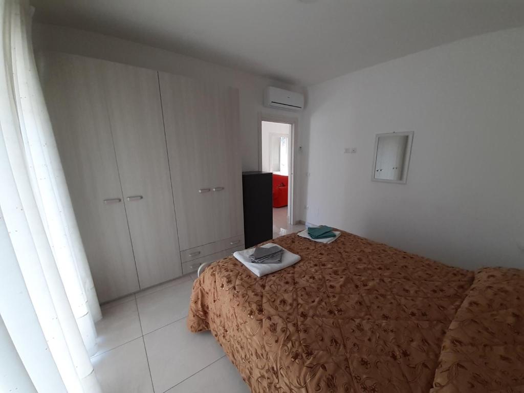a bedroom with a bed with a phone on it at San Marco Beach App Libeccio in Agropoli