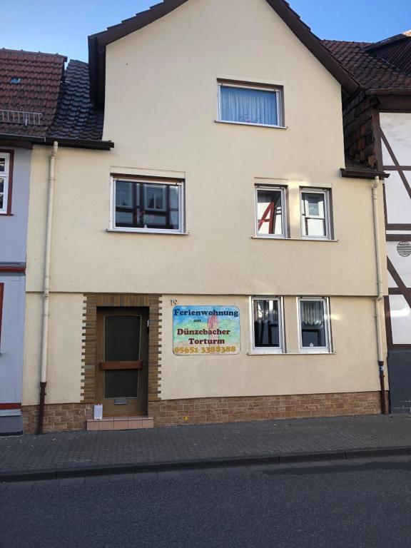 a building with a sign on the side of it at Ferienwohnung beim Dünzebacher Torturm in Eschwege