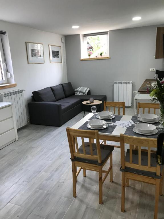 a living room with a table and a couch at Apartment Portorose in Portorož