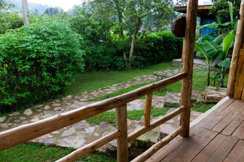 a wooden porch with a stone walkway in a yard at Karungi Camp in Rubuguli