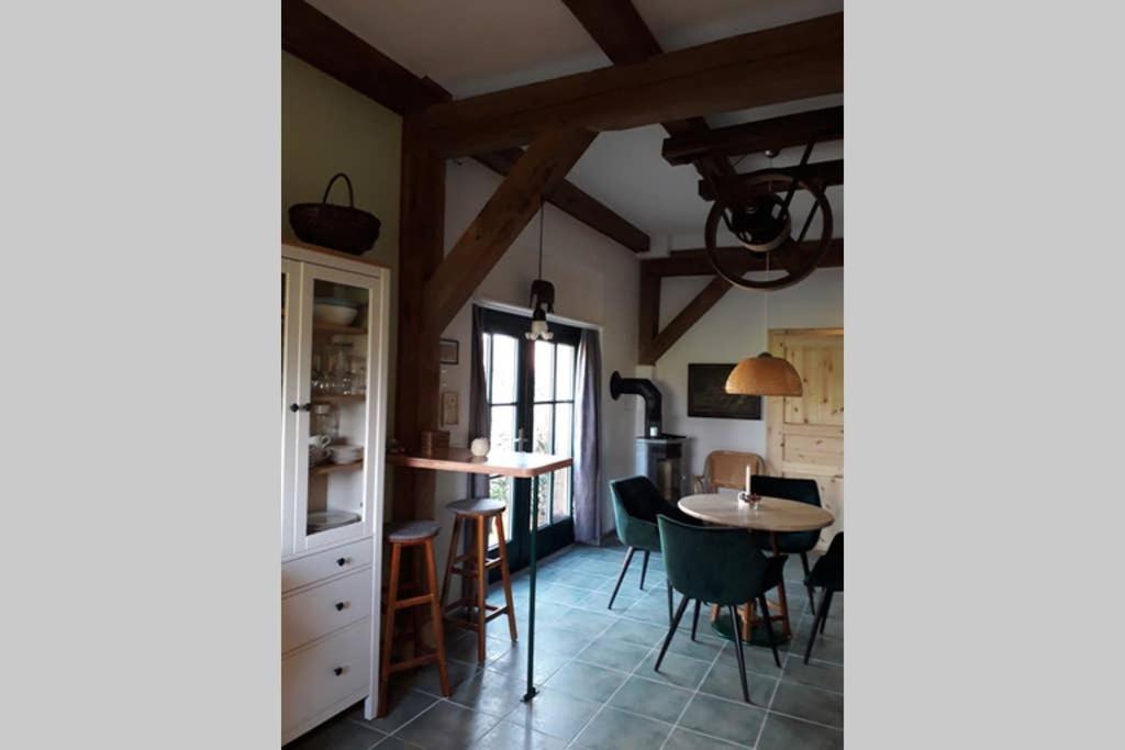 a dining room with a table and chairs at Entspannen im Dorf am See in Zahren