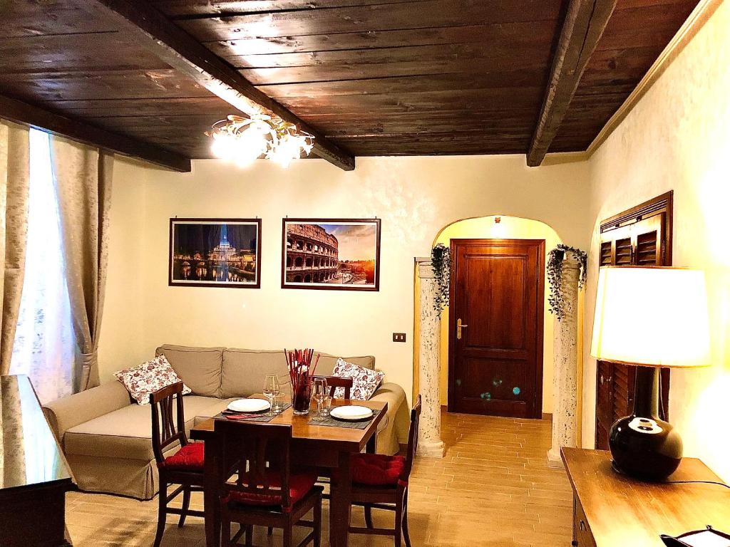 a living room with a table and a couch at La Tana al Flaminio in Rome