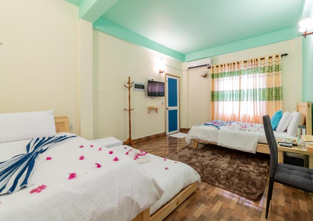 Кровать или кровати в номере Olhumathi View Inn