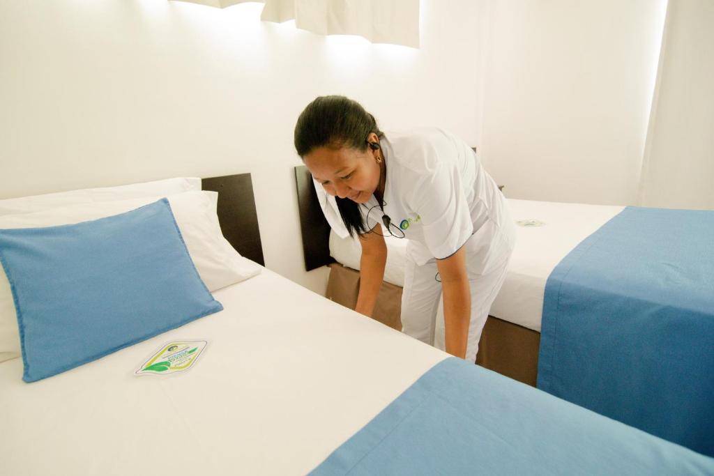 Postel nebo postele na pokoji v ubytování Hotel Maranata Valledupar