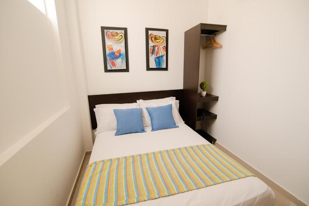 Postel nebo postele na pokoji v ubytování Hotel Maranata Valledupar