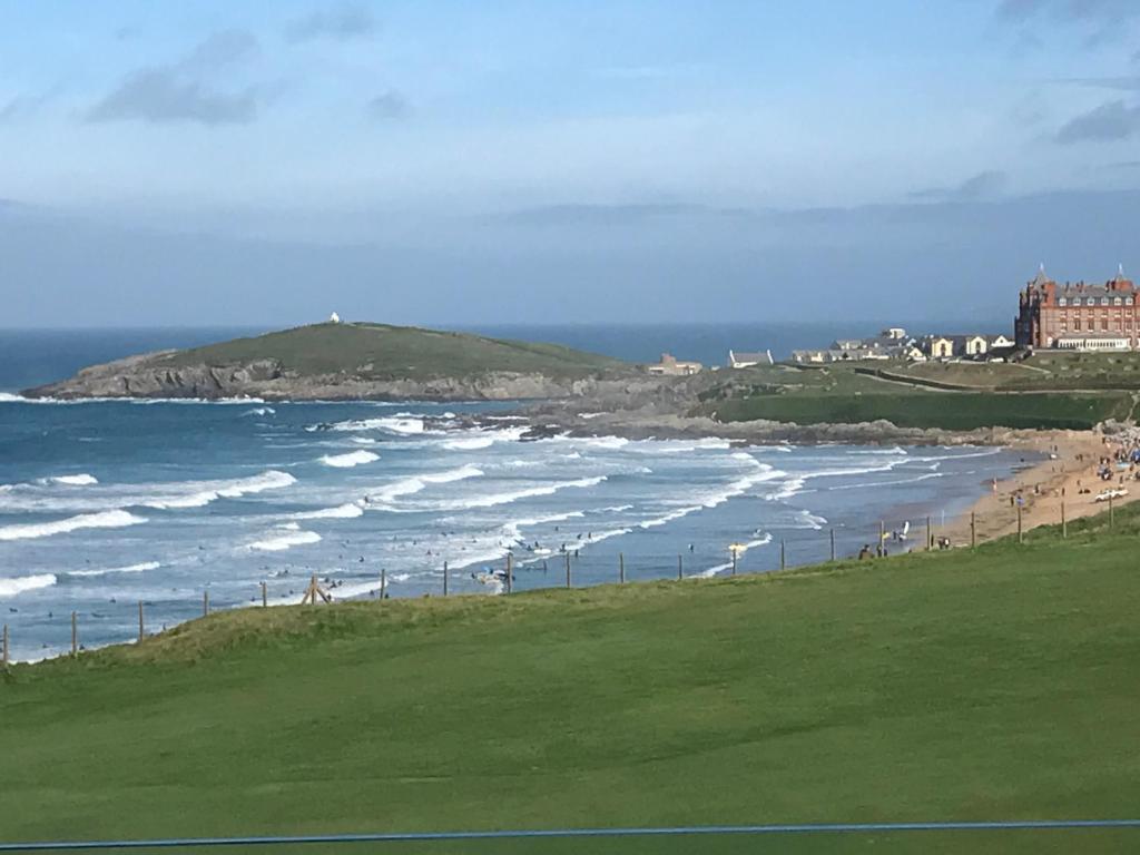 a view of a beach with people walking on the sand at 5 Star Fistral View in Newquay