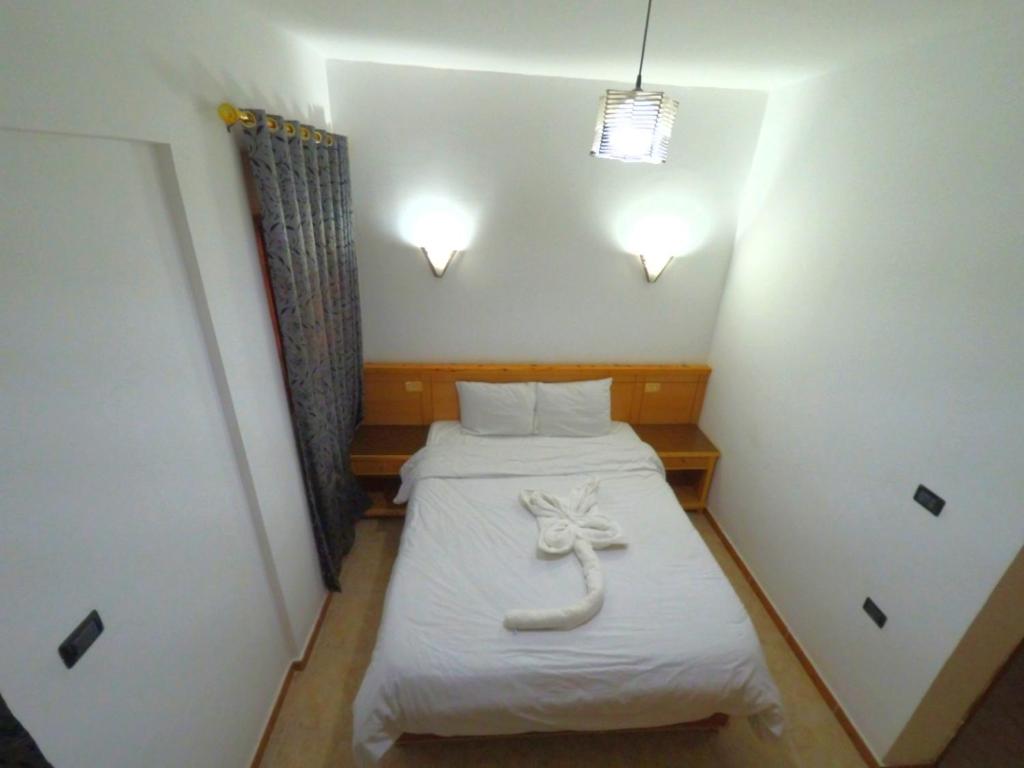 Postel nebo postele na pokoji v ubytování Jimmy Hotel