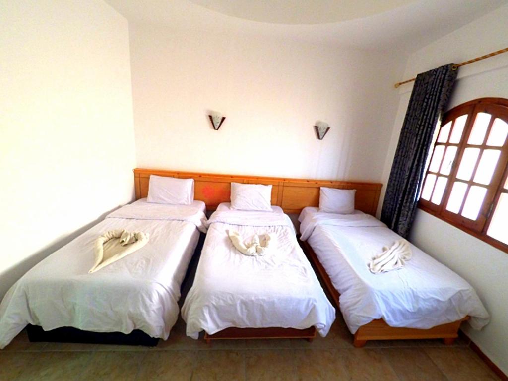 Postel nebo postele na pokoji v ubytování Jimmy Hotel