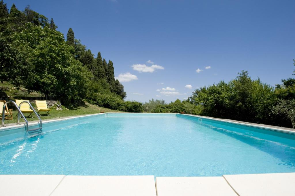 a large swimming pool with blue water at Entire property Florence private pool park in Barberino di Mugello
