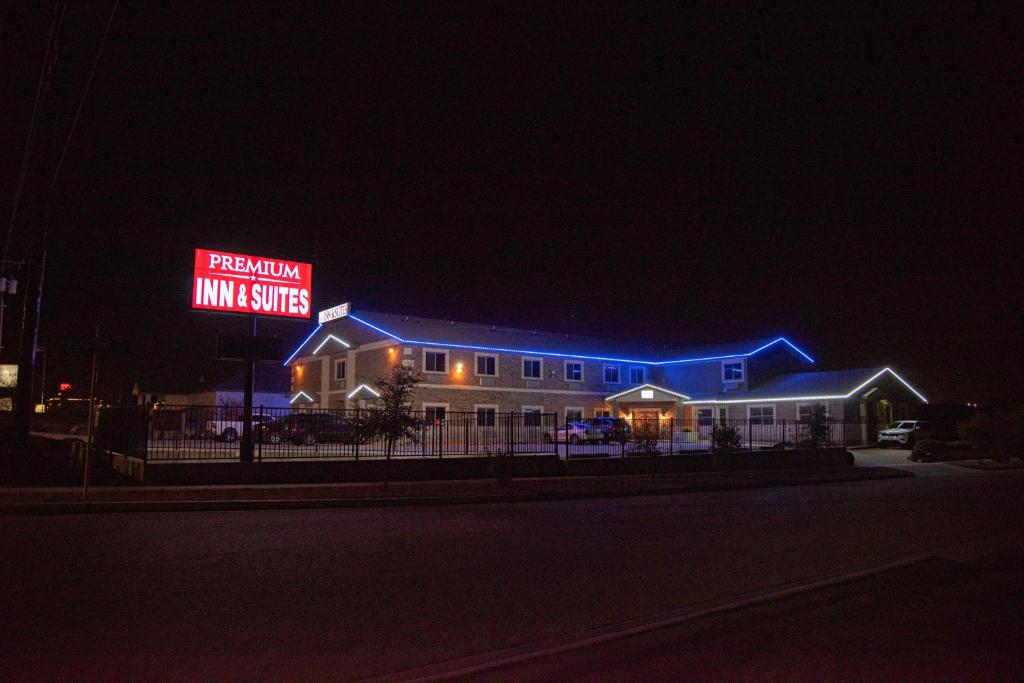 a building with a sign on the side of it at night at Premium Inn and Suites in Killeen