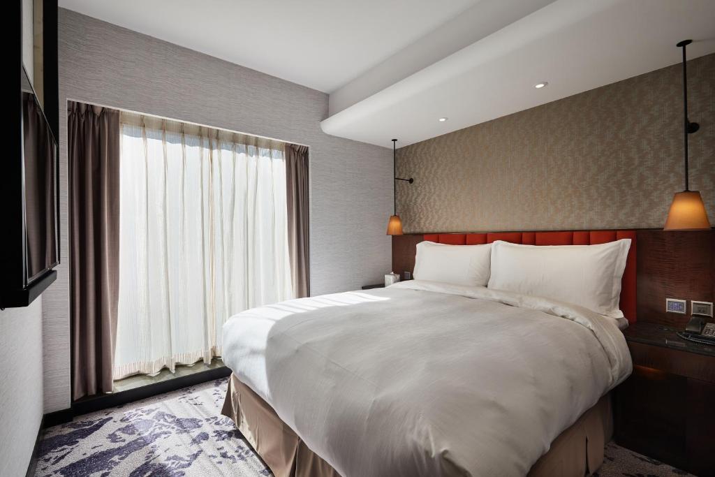 Postel nebo postele na pokoji v ubytování Tango Inn Taipei ZhongShan