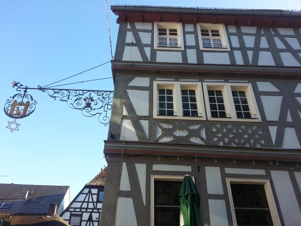 a building with a lantern hanging from the side of it at Hotel Blaues Haus in Otterberg