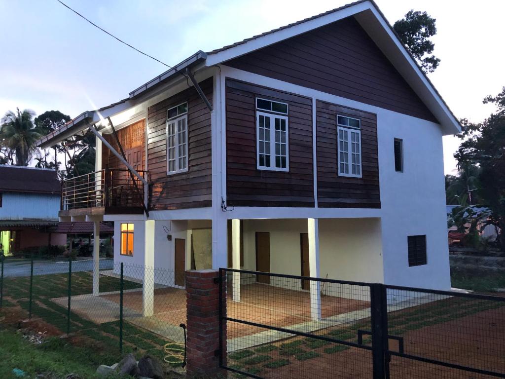 a house with a fence in front of it at Suri Homestay, Taiping in Taiping