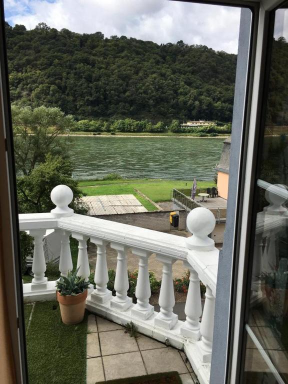a balcony with a view of a body of water at Paradiesisch Wohnen - Loreley in Sankt Goarshausen