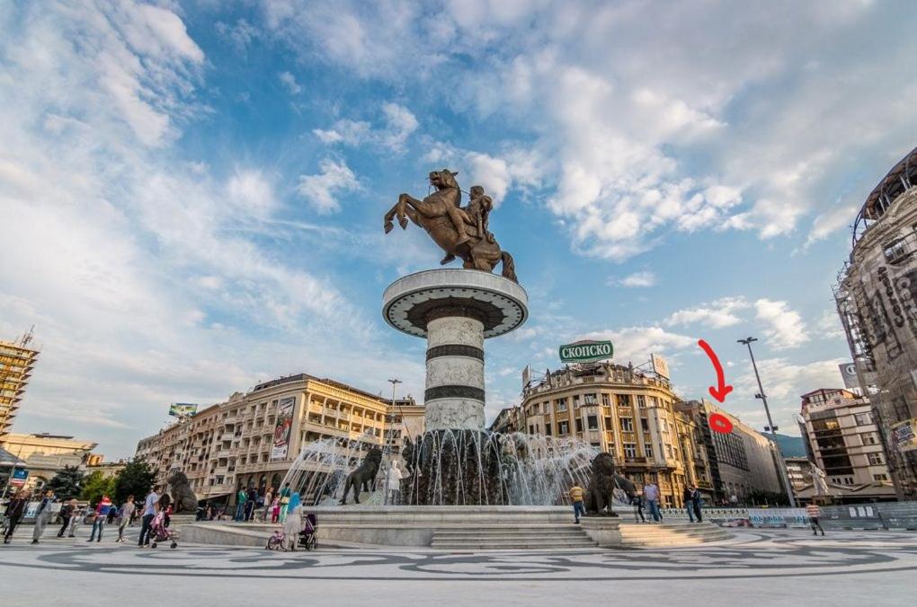 a statue of a man sitting on top of a fountain at Skopje Arch Residence in Skopje