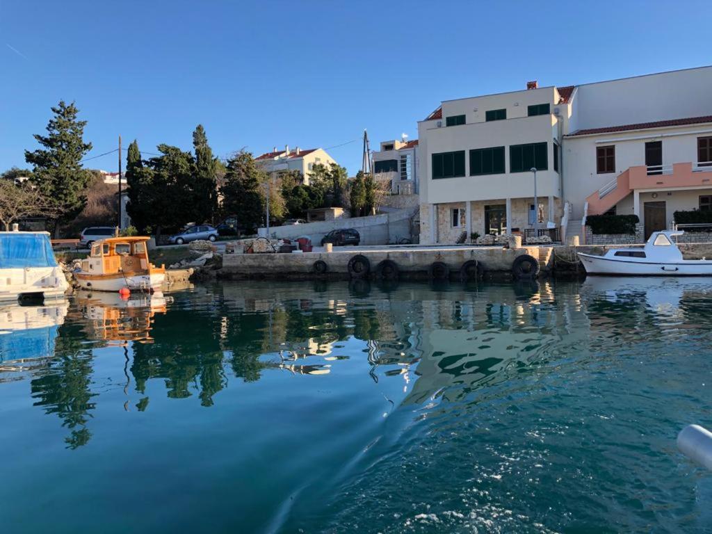 a body of water with boats in a harbor at Stara Kuća Apartments in Šimuni