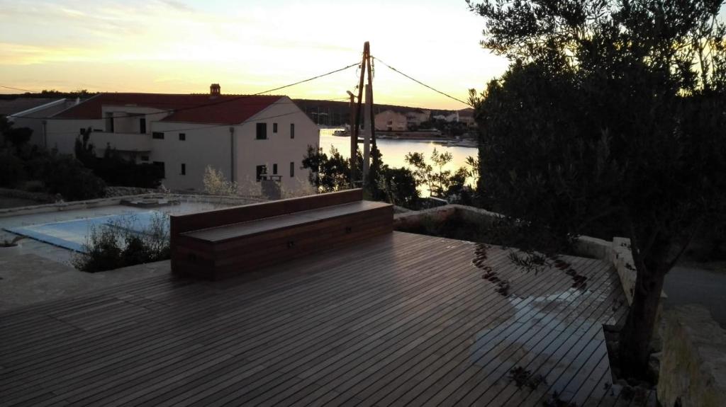 a wooden deck with a bench on top of a house at Stara Kuća Apartments in Šimuni