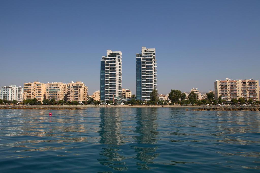 a large body of water with buildings in the background at Olympic Residence Deluxe Apartments in Limassol
