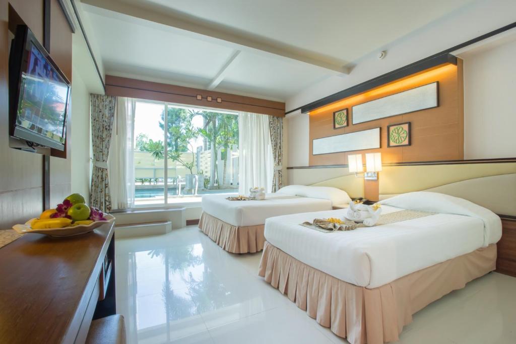 Postel nebo postele na pokoji v ubytování Asia Cha-am Hotel