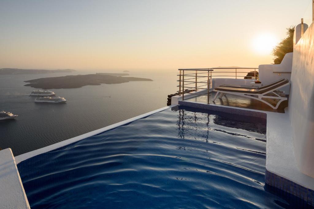 a swimming pool with a view of the ocean at Pegasus Villas in Imerovigli