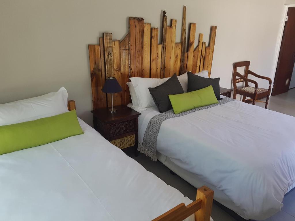 two beds sitting next to each other in a room at Fig Tree in Colesberg
