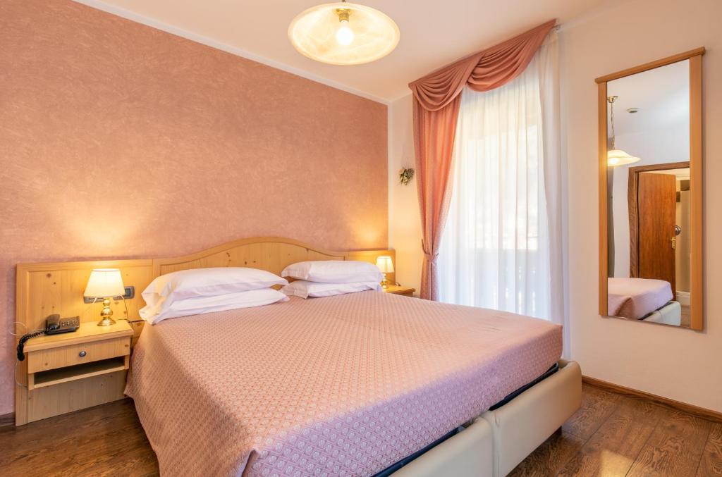 Postel nebo postele na pokoji v ubytování Albergo Conca Verde