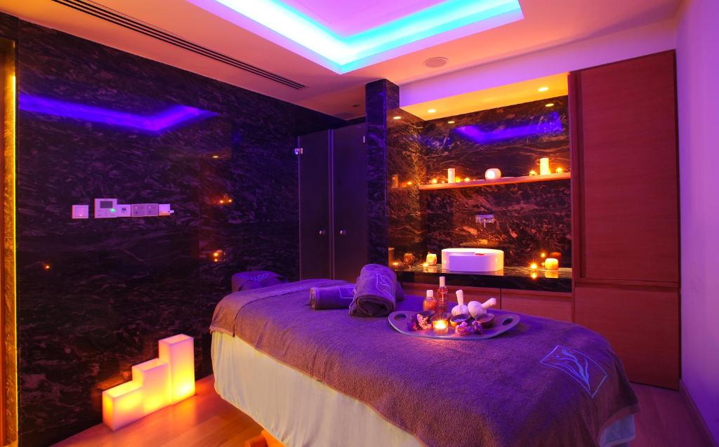 a room with a bed with a table and a window at Olympic Residence Deluxe Apartments in Limassol